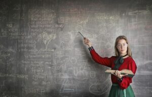 woman pointing to the chalk board